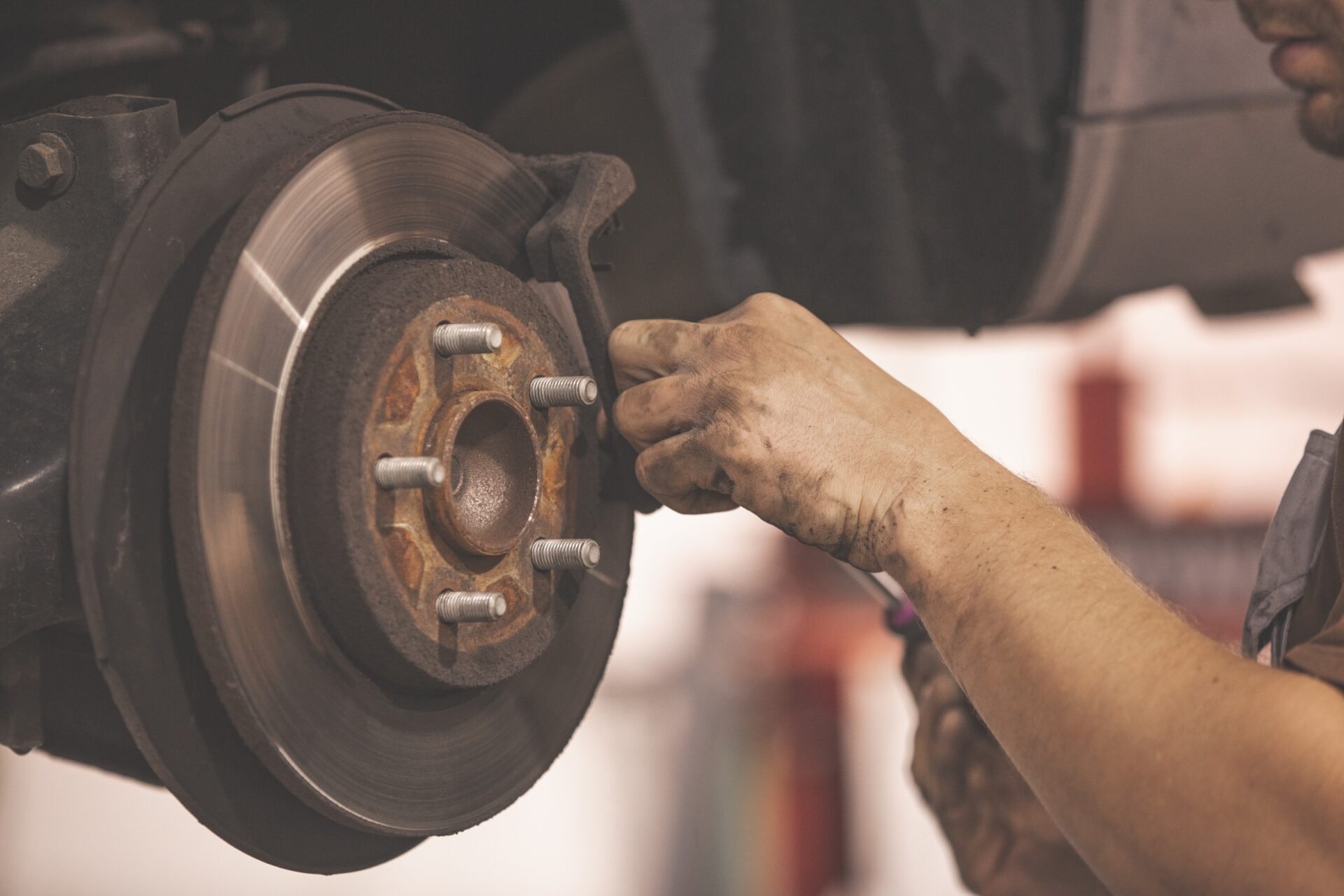 mechanic working on braking system for car